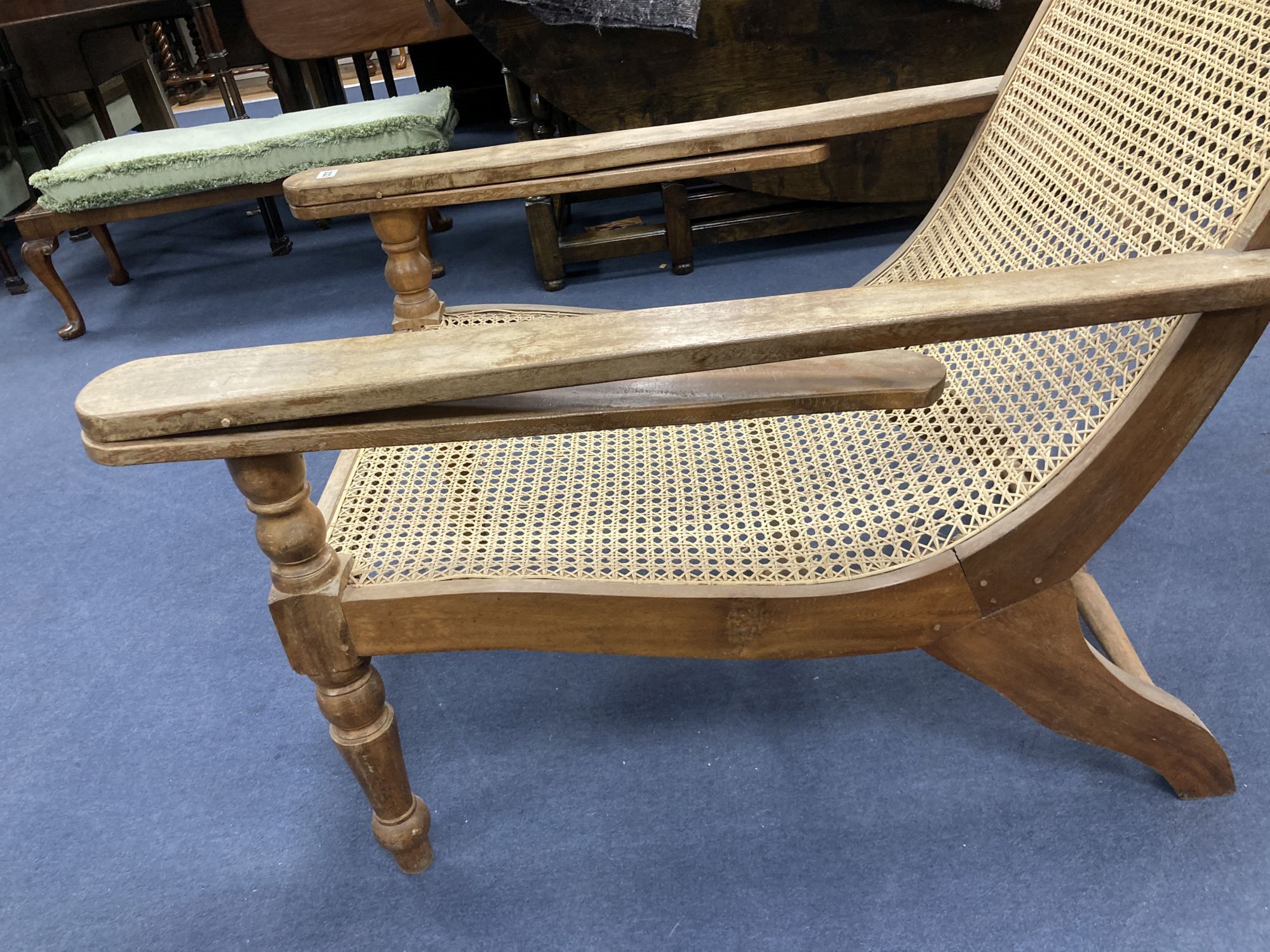 An early 20th century Anglo-Indian caned weathered plantation chair, width 66cm, depth 104cm, height 91cm
